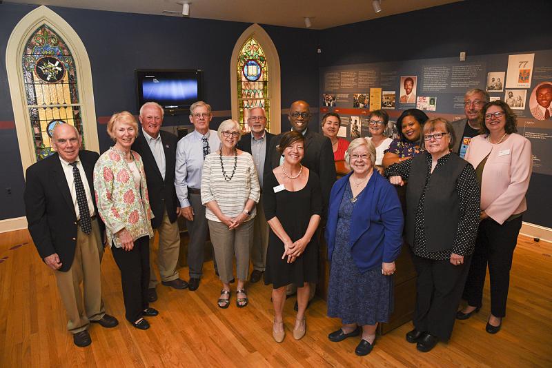 Gathered at the exhibit (l-r) in back are Milton Councilman Sam Garde, Kathleen Garde, Sen. Dave Wilson, Councilman Kevin Kelly, Joy Kelly, Mayor Ted Kanakos, Diaz Bonville, Theresa Dattilo, M.J. Ostinato, Alonna Berry, Al Knight, Mary Knight and in front, Heidi Nasstrom Evans, Lee Revis-Plank and Marie Mayor.